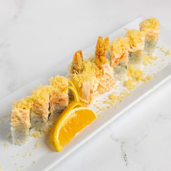 Jojo Japanese Hibachi & Sushi's sushi roll with tempura shrimp, crab, and orange slices on a white plate.