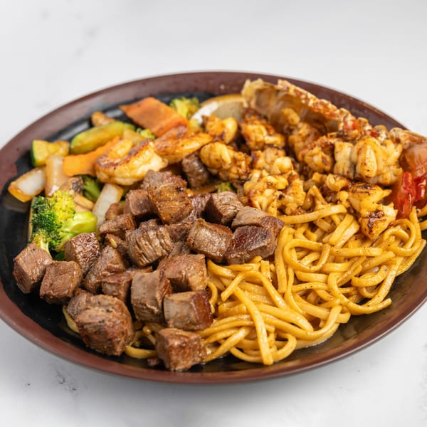 Jojo Japanese Hibachi & Sushi combo with steak, lobster, shrimp, noodles, and mixed vegetables.