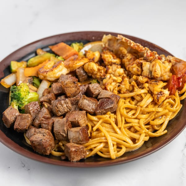 Jojo Japanese Hibachi & Sushi's hibachi dinner with steak, lobster, shrimp, noodles, and vegetables.